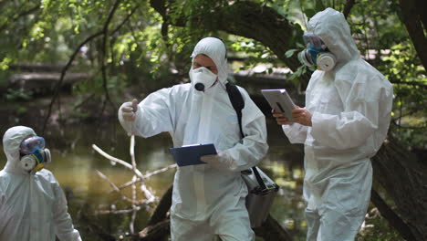 scientists in hazmat suits conducting environmental research