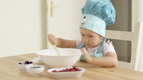 Adorable-smiling-toddler-at-mixing-bowl