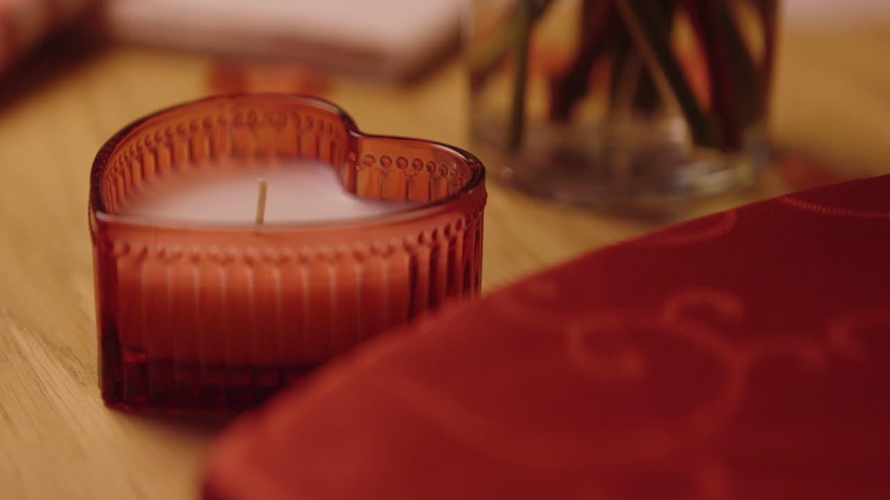 Heart-Shaped Candle on a Wooden Table
