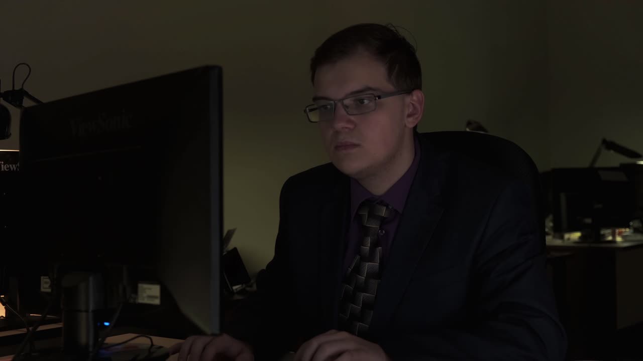 Man Working on Computer at Night