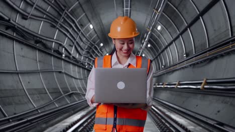 Engineer Working on a Laptop in a Tunnel