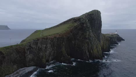 4k aerial drone footage side to side of cliffs and rocks with lighthouse at neist point on coast of scotland uk