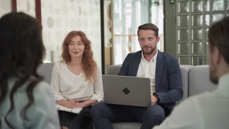 Business-Meeting-Between-Two-Women-And-Two-Men-At-An-Office-5