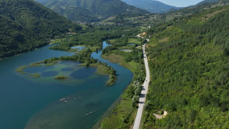 Aerial-view-of-a-large-artificial-lake-located-next-to-an-intercity-road