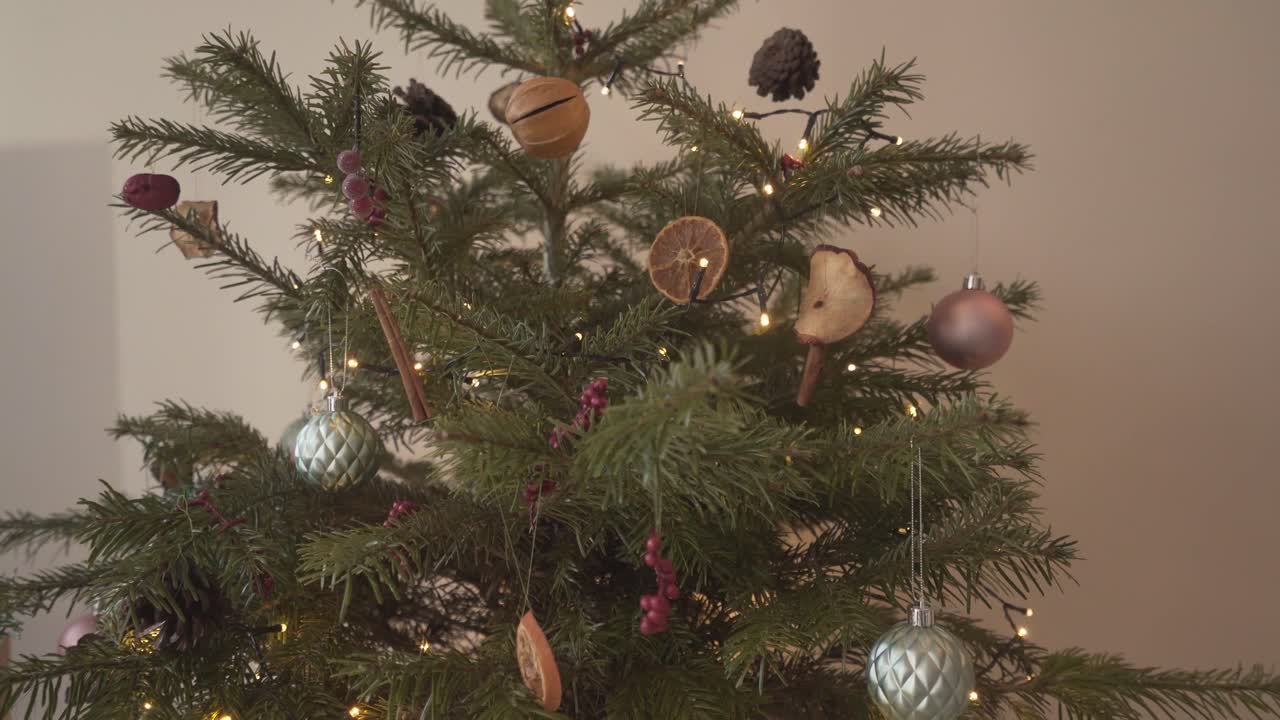 Small real christmas tree pine with beautiful decoration at home to celebrate important festivity