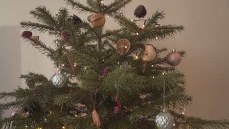 small real christmas tree pine with beautiful decoration at home to celebrate important festivity