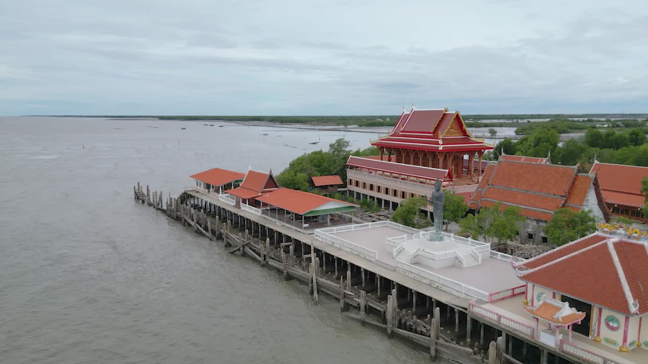 Thai Buddhist temple surrounded by seawater off the coast of a sunken village