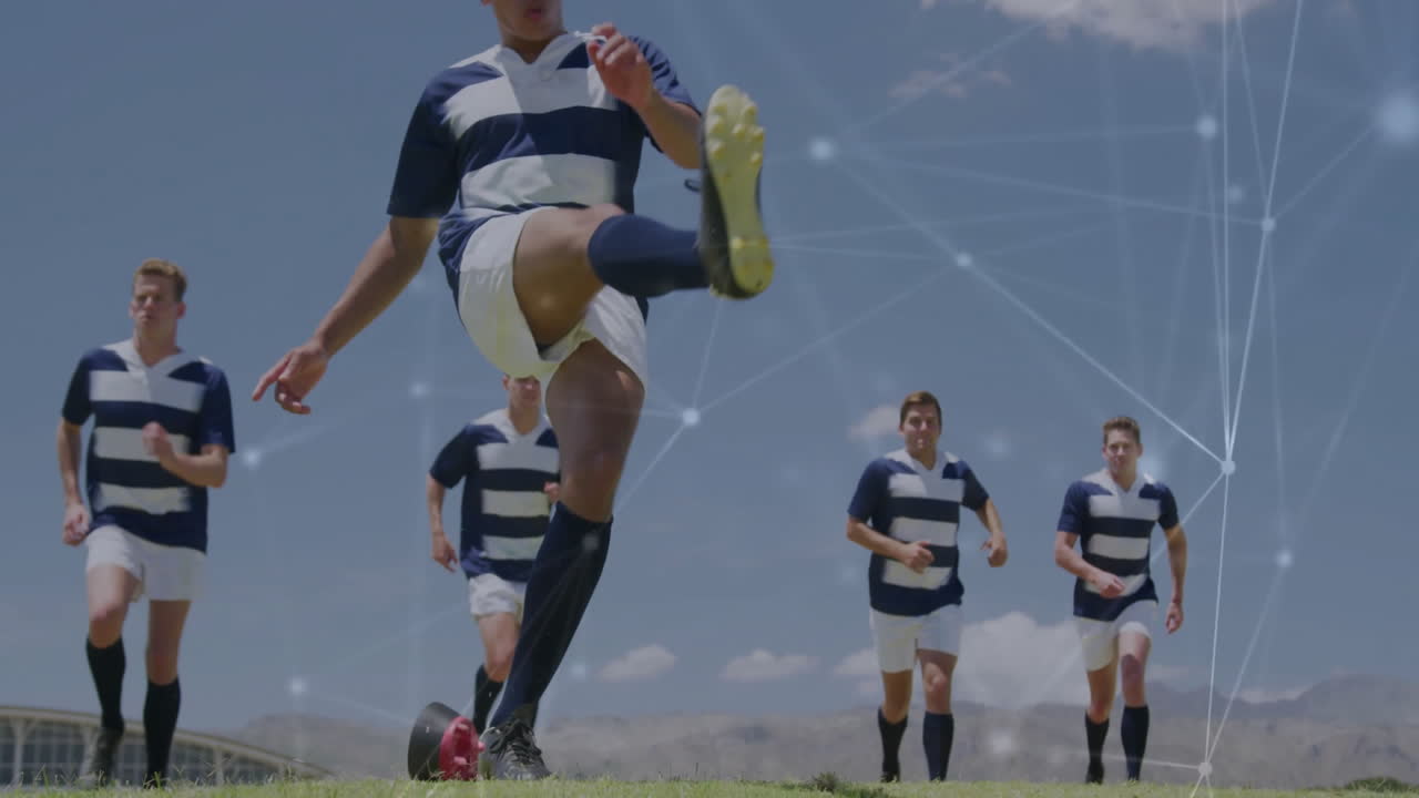 Kicking ball, soccer players in striped uniforms with network connections overlay
