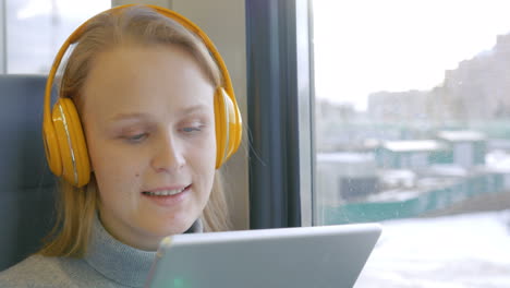 woman in headphones listening to music on the way