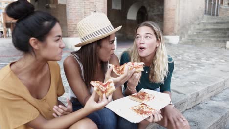 happy millennial friends enjoying the weekend together while eating pizza