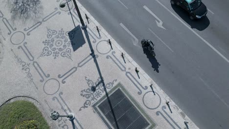 art decorated sidewalk drone top view and moving upward revealing the entire sidewalk and the main road