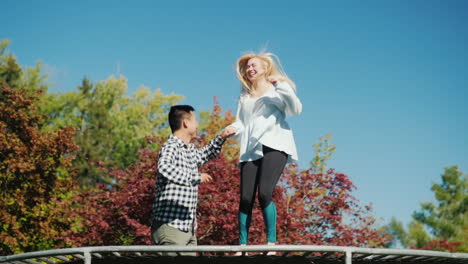 couple have fun on trampoline