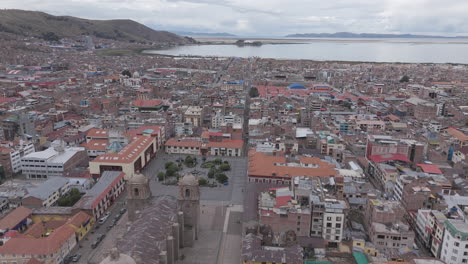 drone shot above plaza mayor de puno peru near the church or cathedral log