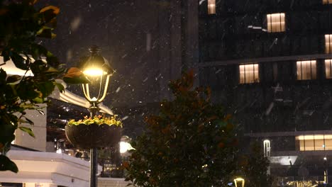 snowy night cityscape with streetlights