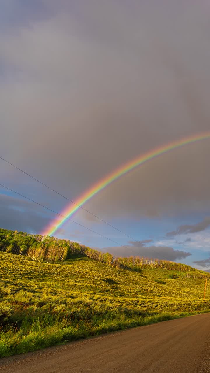 Vertical 4k Timelapse, Rainbow and Clouds Above Mountain Road and Beautiful Sunny Landscape
