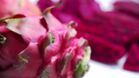 Panning-of-red-dragon-fruit-vibrant-color-close-up-of-seeds-Red-and-white-dragonfruit-Red-Dragon-Fruit-Slices-and-Cultivating-Exotic-Plants-pitaya