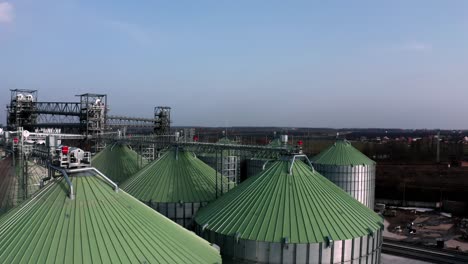 metal silos on field aerial view. large containers for storing and processing grains. silver grain elevators in farmland. storage tank view from above. silo with grain.