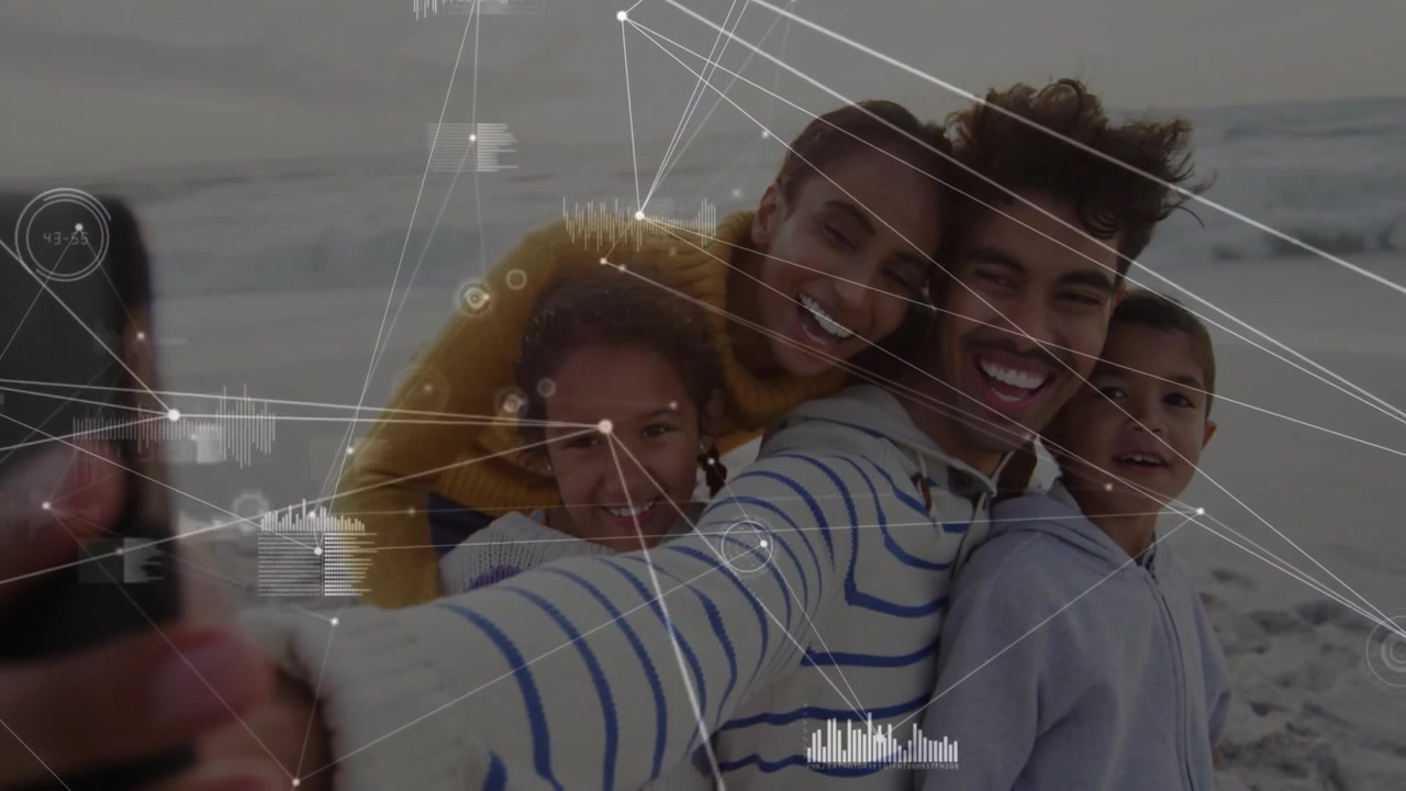 Man holding phone and aligning family on beach, tapping shutter capturing selfie tech data overlay