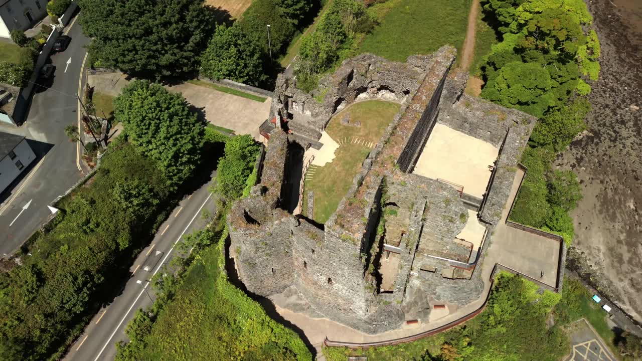 Advancing overhead aerial video of Carlingford Castle and Carlingford Lough in Carlingford, County Louth, Ireland on a bright and sunny day. Filmed in 4K, 60FPS and with Rec709 color.