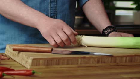 Close-up-tracking-video-of-tossing-leek-in-the-kitchen