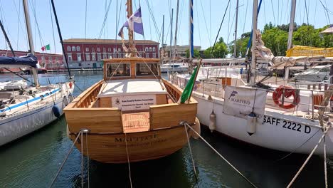 wooden and white boats docked in naples harbor