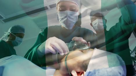 animation of flag of nigeria waving over surgeons in operating theatre