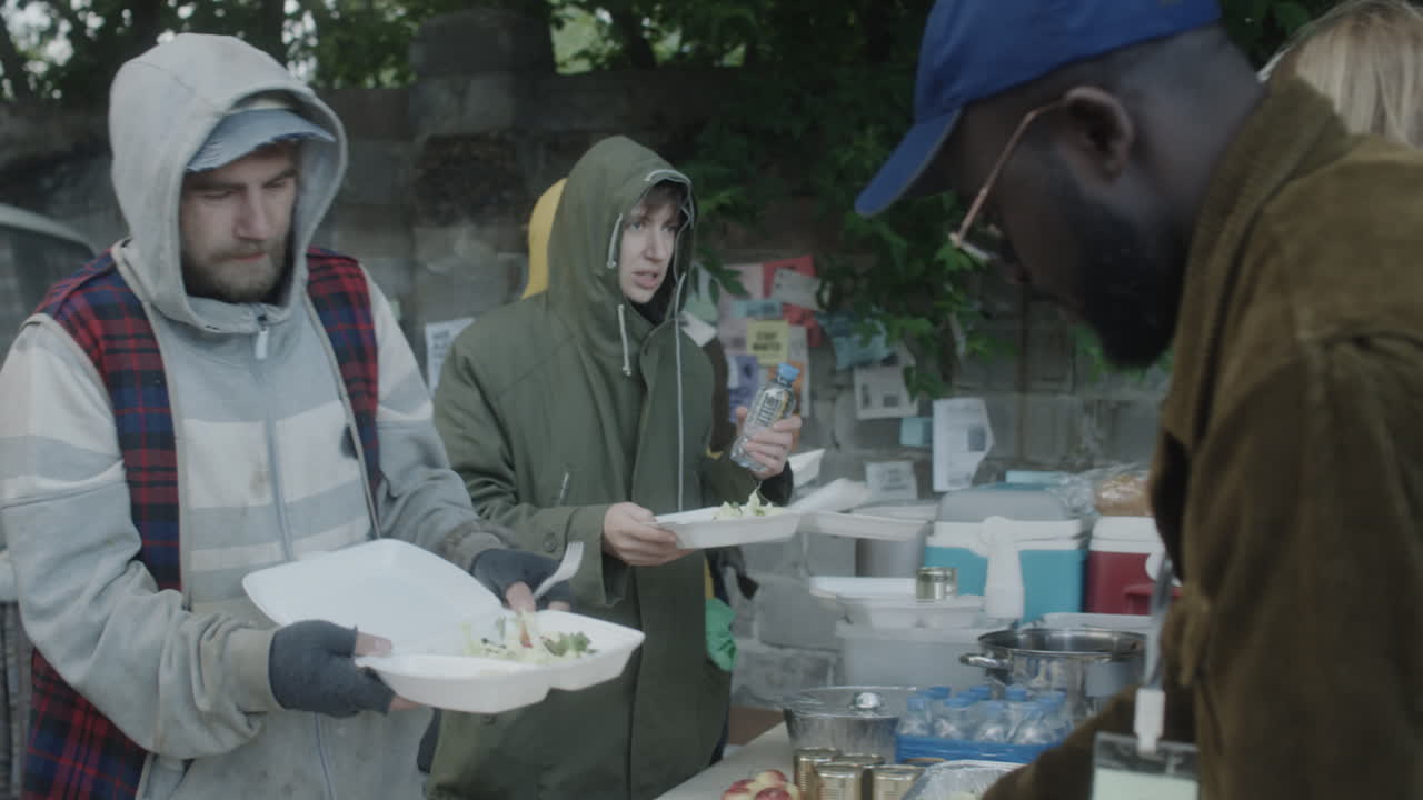 Volunteers distributing food and water to people in need