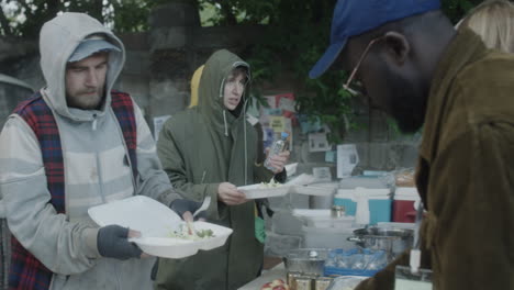 volunteers distributing food and water to people in need