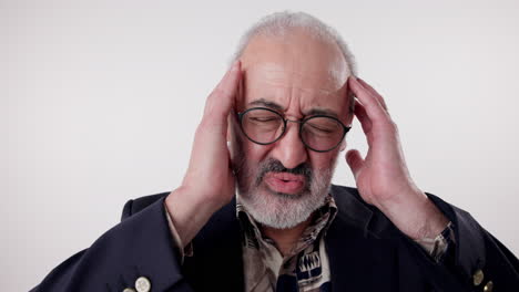 senior man experiencing headache and stress