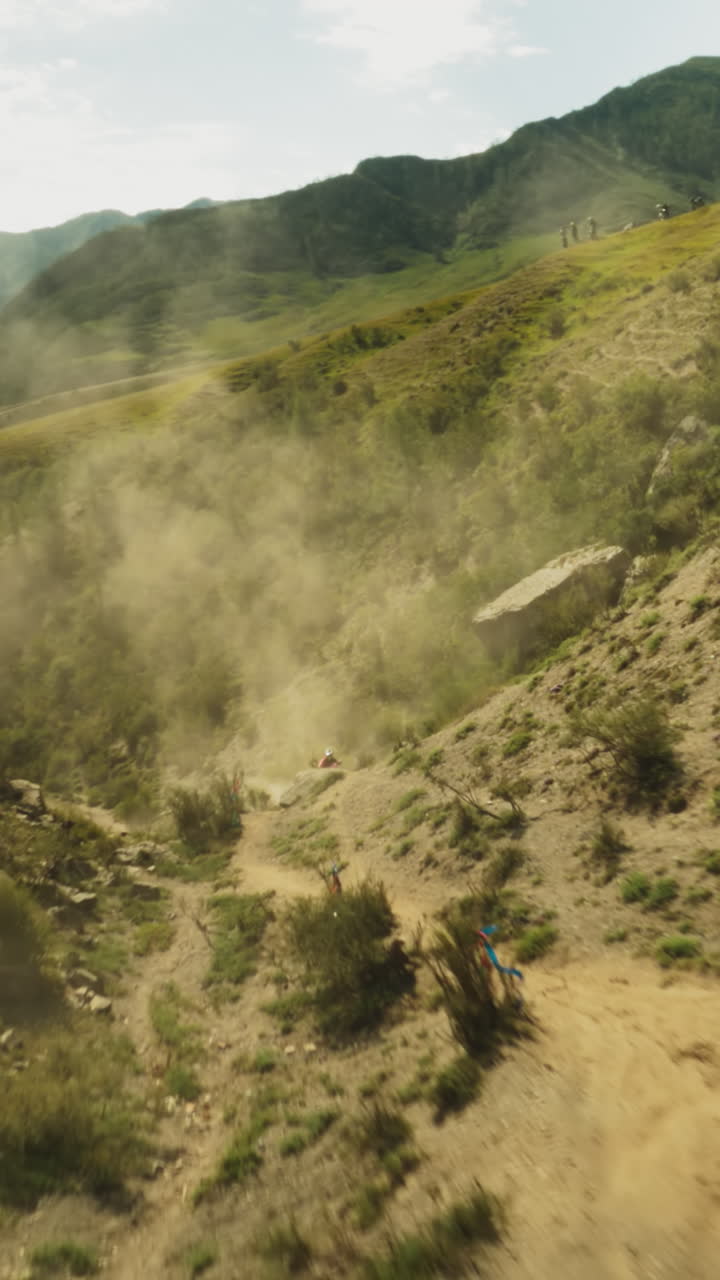 Motocross racing on mountain slopes fpv. Professional motorbikes ride vehicles along hollow competing for victory. Sports contest at highland