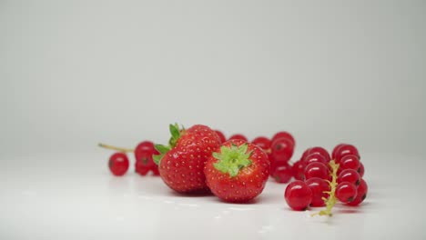 beautiful red strawberries and cherries in pure white background - close up shot