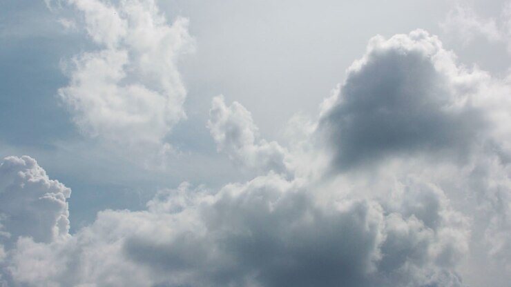 Close Up of clouds moving across a clear blue sky