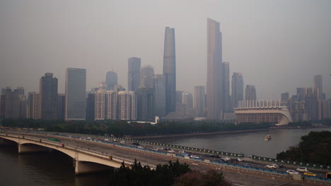 widok na centralną dzielnicę budynków guangzhou i most guangzhou nad rzeką perłową z dużym ruchem po południu