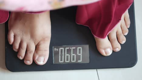 person standing on a weight scale