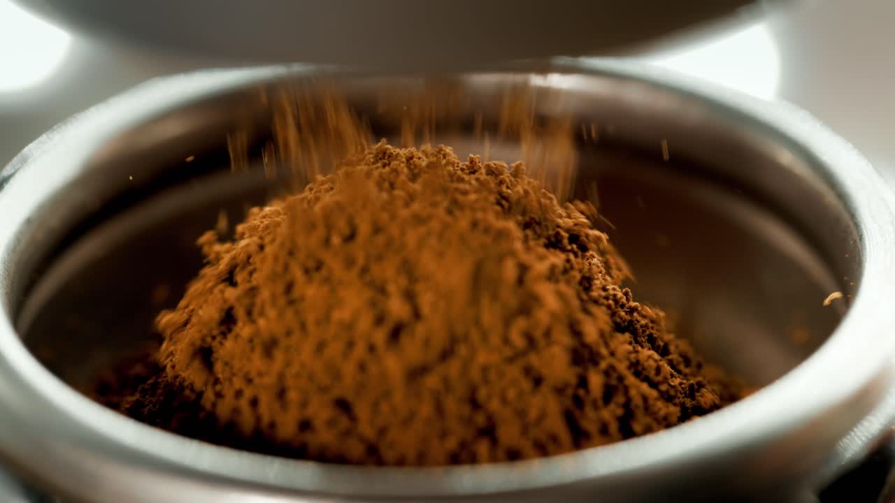 Coffee Grounds Pouring Into Holder