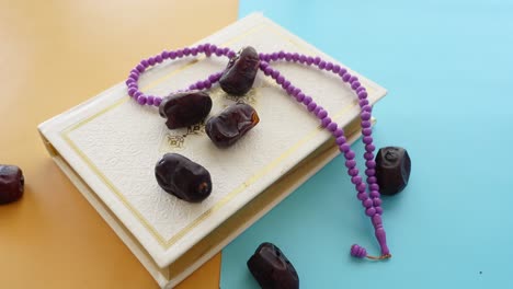 islamic book with prayer beads and dates