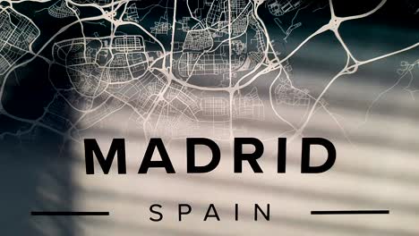 madrid, spain title with map revealed by sunshine