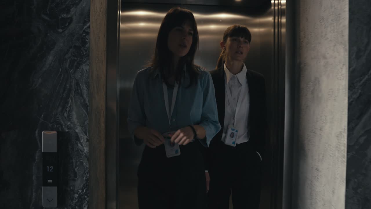 Businesswomen Walking in Office Hallway