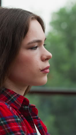 lady surveys world beyond expansive glass. woman forlorn expression unravels intricate tapestry of inner struggles. maze of emotions intricating inner world