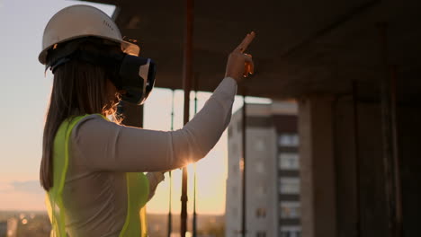 female engineer in hardhat with vr glasses designing construction project at manufacturing plant