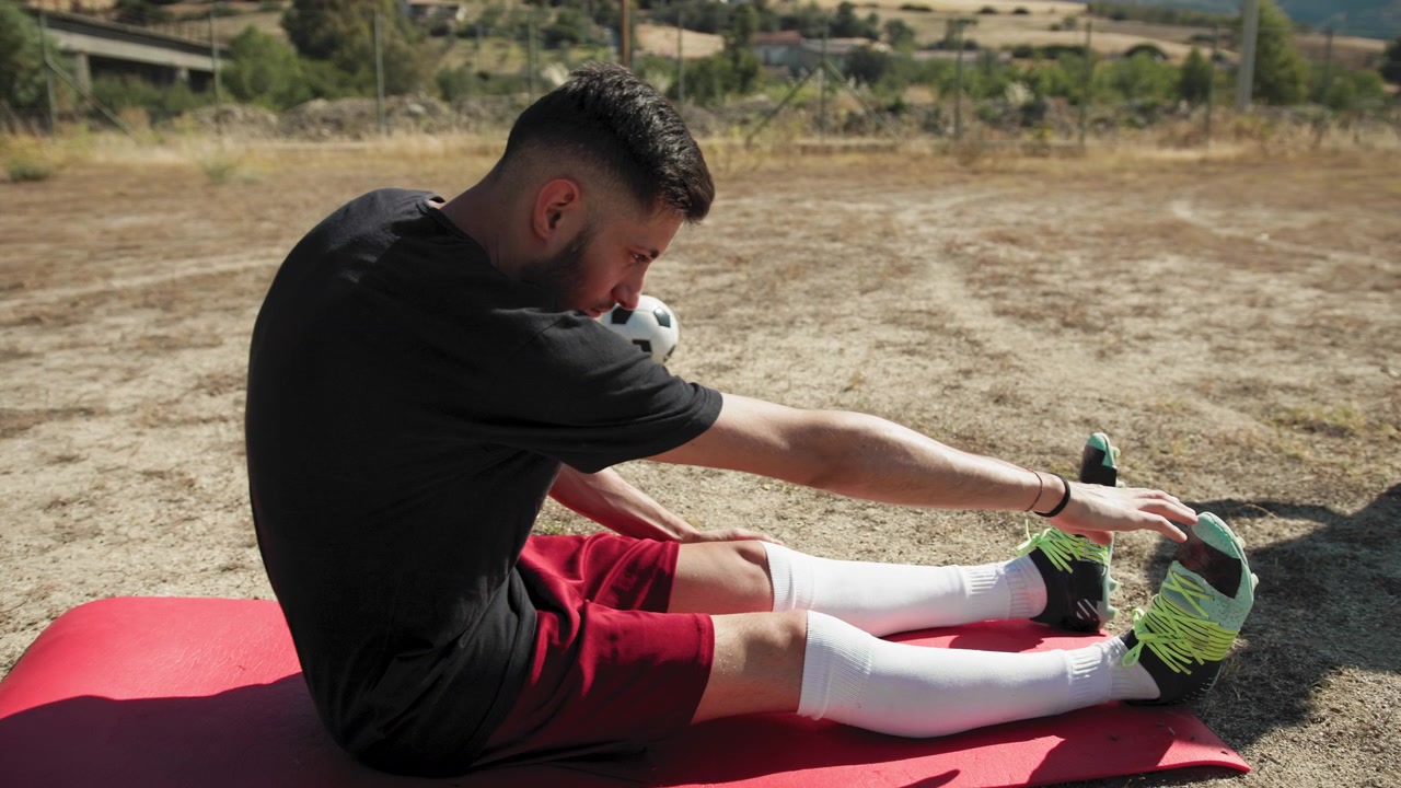 Sunny Day Over The Soccer Player Stretching