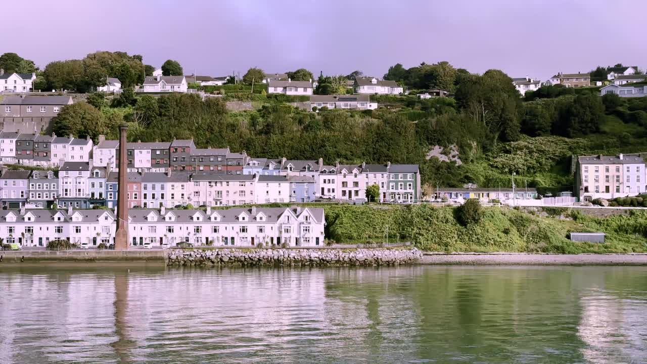 Passing Cobh's colourful houses and old industrial chimney, county Cork, Ireland