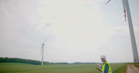 engineer using digital tablet on wind turbine farm 6