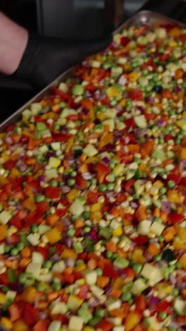 chef preparing mixed vegetables in commercial kitchen