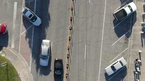 top view of asphalt car parking area with cars driving