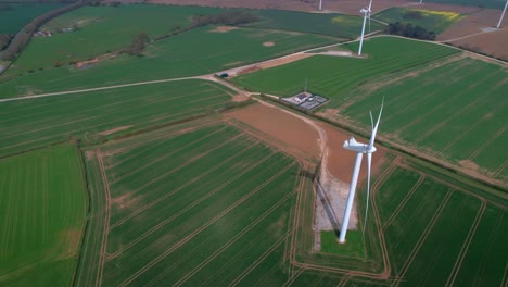 lissett airfield rotating wind turbine farm on agricultural farmland aerial view overlooking yorkshire countryside