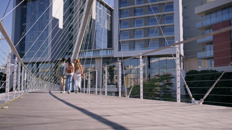 people walking on a pedestrian bridge in an urban setting