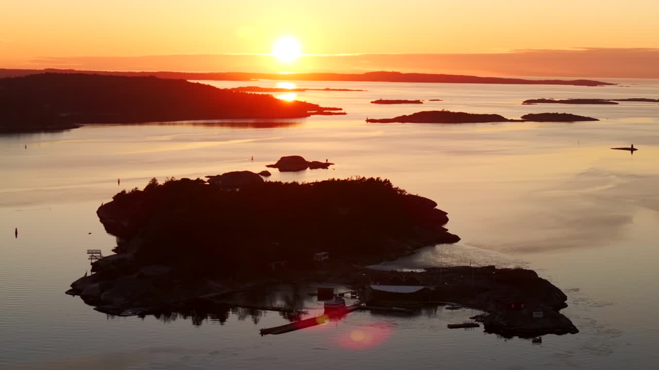 Strömstad Stromstad Sweden aerial drone Scandinavia Arctic Circle sea islands golden sunset sun rays on horizon peaceful calm still Sandelfjord Fjord Skagerrak Baltic marina harbor circle right