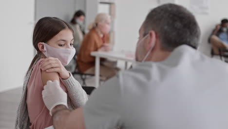 caucasian girl being vaccinated