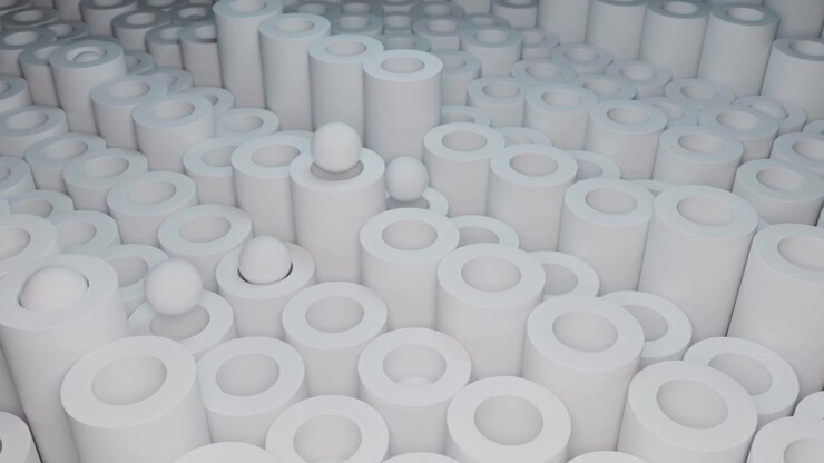 Dense white cylindrical shapes with circular openings fill the frame in a clean abstract composition. Soft even lighting highlights the smooth surfaces